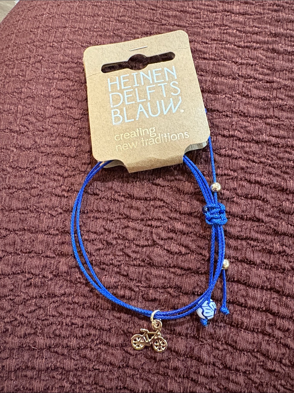 25-bracelet with a gold bicycle charm from the Dutch brand Heinen Delfts Blauw.